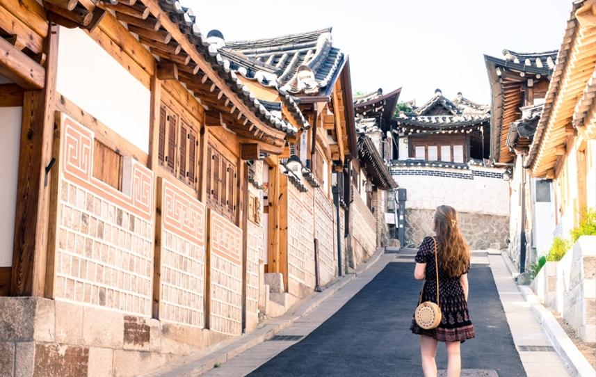 Young woman walks around Seoul, South Korea on her study abroad